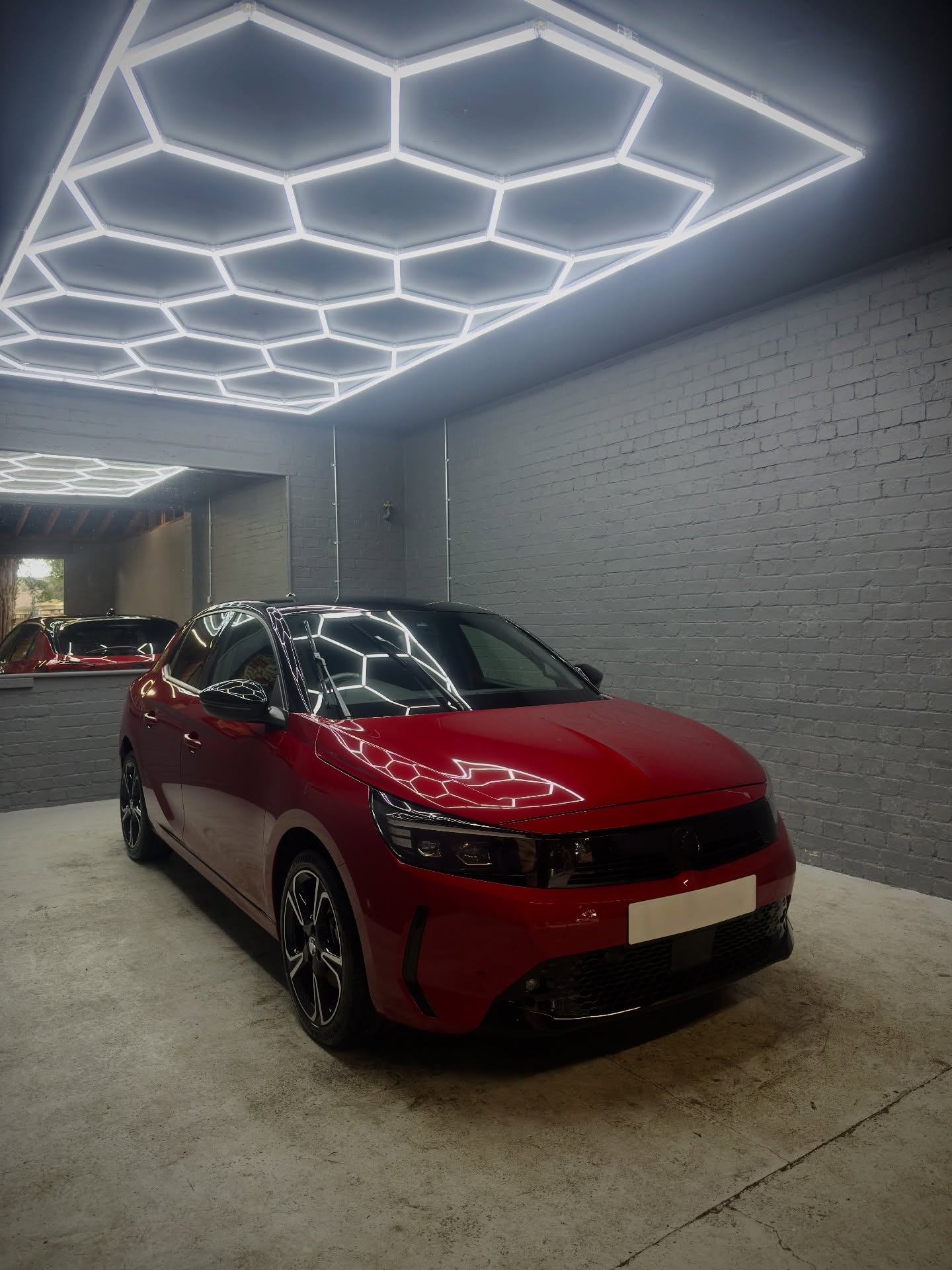Red Vauxhall Corsa under studio lighting