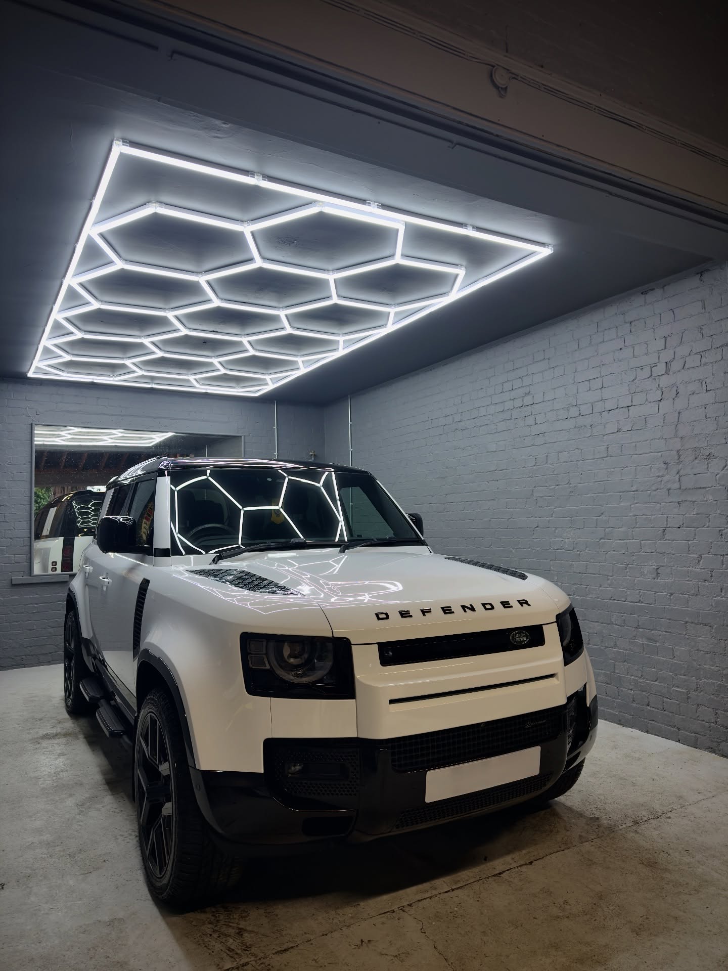 White Land Rover Defender under studio lighting